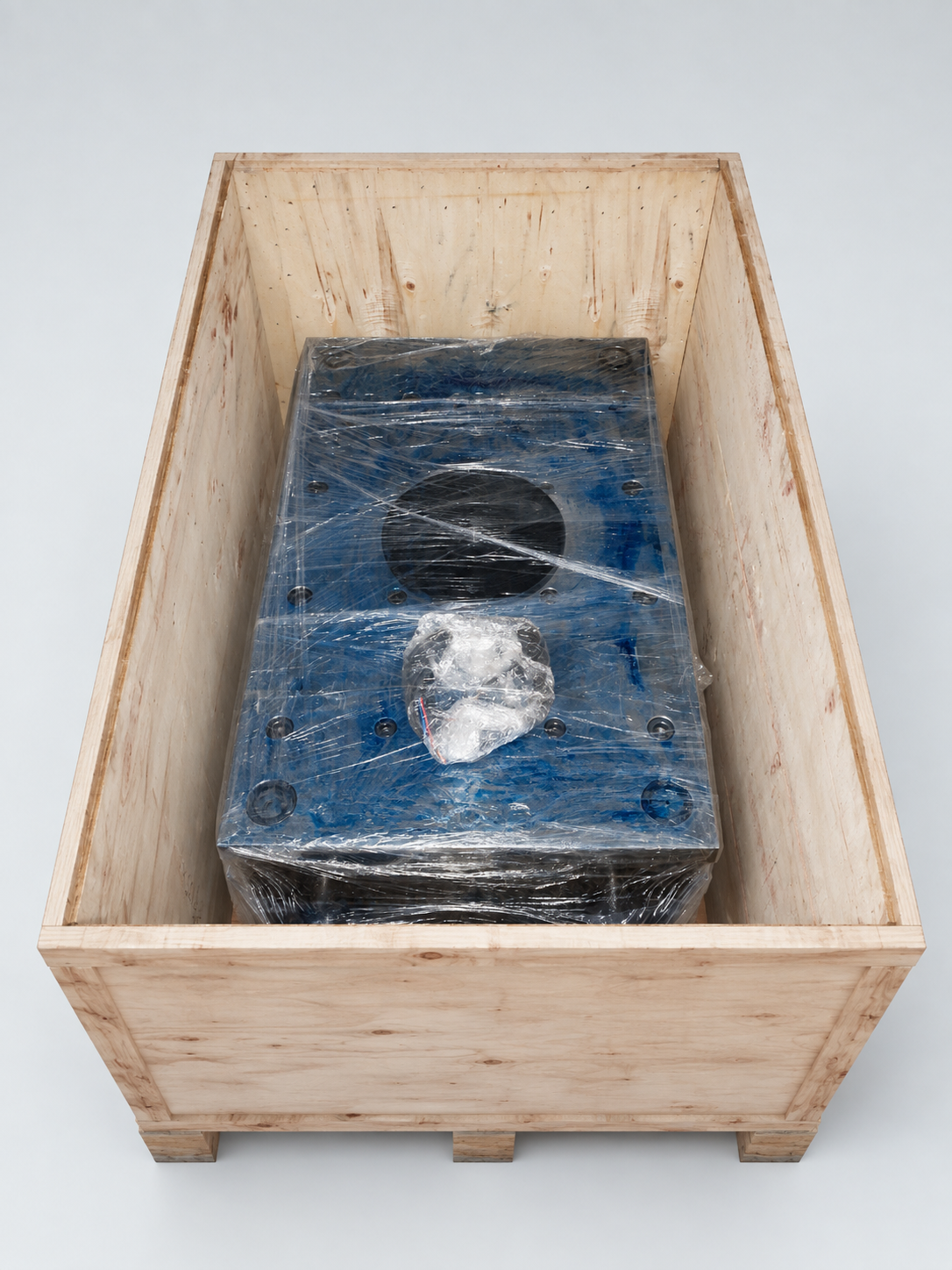 Styled view of wrapped tooling prepared inside its wooden export crate