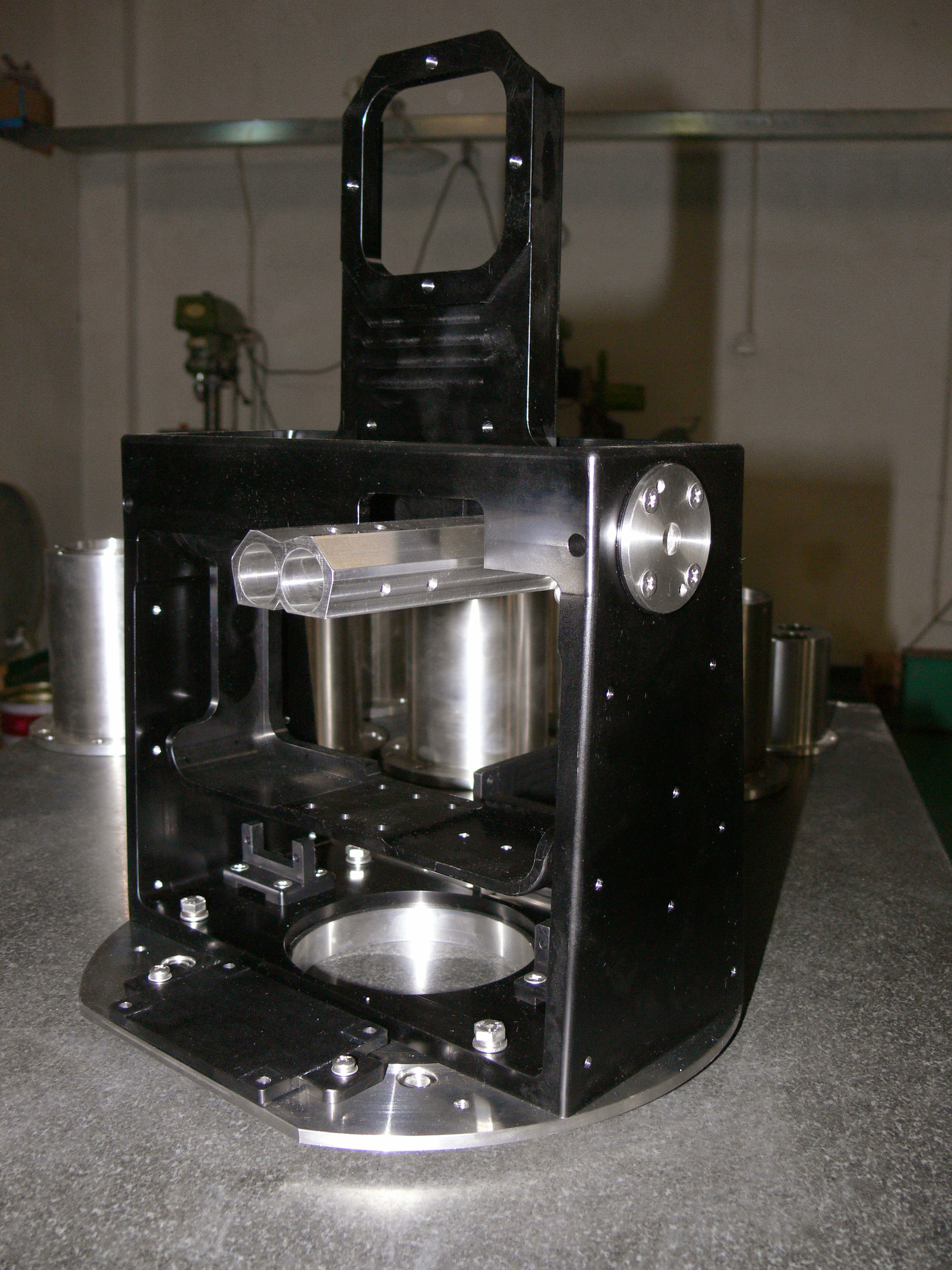 Machined sensor gimbal frame on its circular metal base