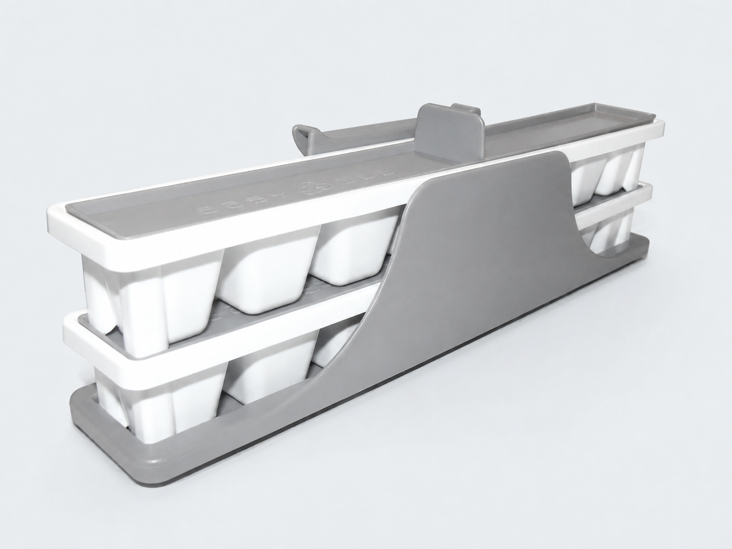 White moulded trays stacked in their grey supporting cradle